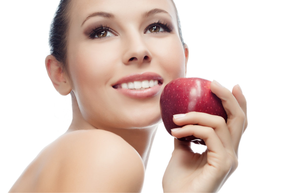 girl holding apple smiling